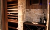 Rubble buff wine cellar with wood accents